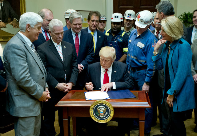 President Donald Trump signs H.J. Res. 38, disapproving the Stream Protection Rule in the Roosevelt Room of the White House on February 16, 2017 in Washington, DC. Trump might not be able to save coal, but he can roll back the industry regulations that existed under President Obama. (Photo: Ron Sachs-Pool / Getty Images)