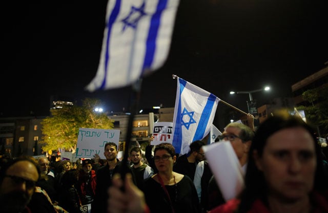People march through Rotschild Boulevard to protest Israel's Prime Minister Benjamin Netanyahu over alleged corruption in Tel Aviv, Israel on January 13, 2018. The concept of dissent in Israel is often allowed only within the framework of Zionism. (Photo: Gil Cohen Magen / Anadolu Agency / Getty Images)