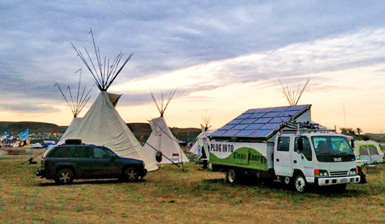 Portable solar arrays helped power the Oceti Sakowin Camp, which rose on the north end of the Standing Rock Reservation in the summer and fall of 2016 in opposition to the Dakota Access Pipeline. Though primarily powered by wood and gasoline, the camps also ran on a great deal of solar. (Photo: Saul Elbein)