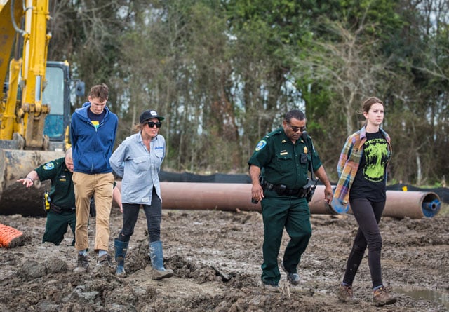 Police lead protesters off a Bayou Bridge Pipeline construction site after the activists staged a sit-in on Monday. (Photo: © 2018 Julie Dermansky)