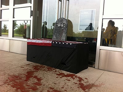 A coffin sits at the entrance to ALEC headquarters.