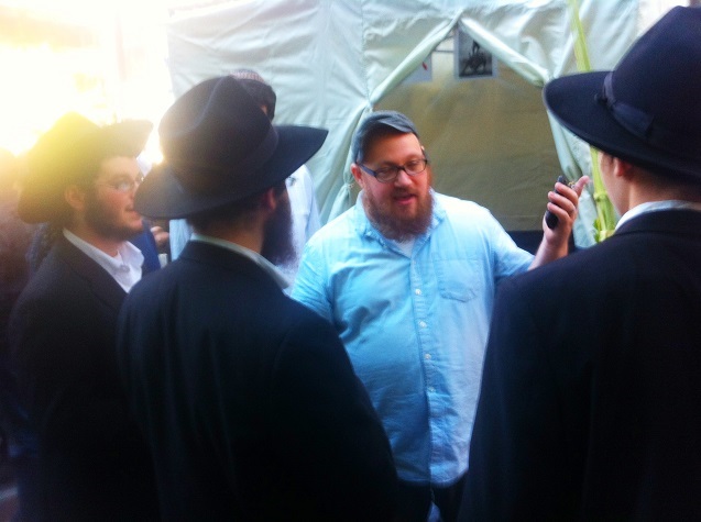 Dan Sieradski in discussion with Orthodox men critical of his activities. (Photo: Joshua Stephens).