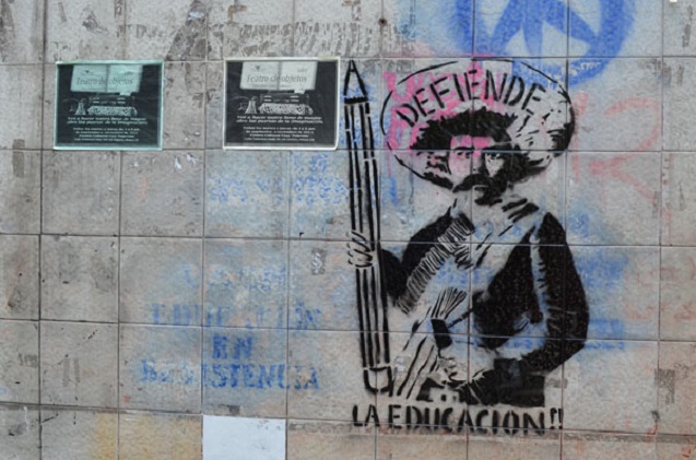 Stencils and graffiti have lined the major avenues of the marches. Here the iconic Emiliano Zapata holds a pencil stating “Defend Education.” (Photo: Andalusia Knoll / Upside Down World).