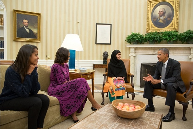 President Barack Obama, First Lady Michelle Obama, and their daughter Malia meet with Malala Yousafzai, the young Pakistani schoolgirl who was shot in the head by the Taliban a year ago, in the Oval Office, October 11, 2013. (Official White House Photo by Pete Souza)