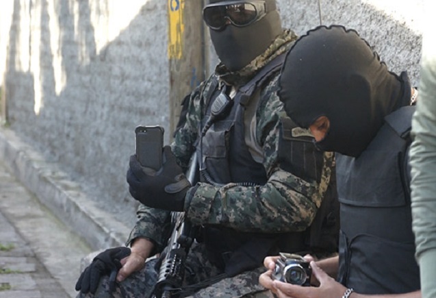 Members of the military police used video and still cameras to record neighbors, friends, and human rights workers who arrived at the scene. (Photo: Jesse Freeston)