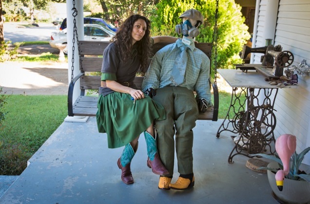 Kim Feil on her front porch in Arlington with dummy 'Ben Zene,