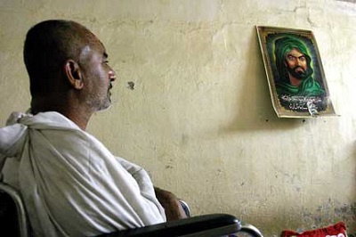 A disabled oil worker in a wheelchair at home. (Photo: David Bacon)