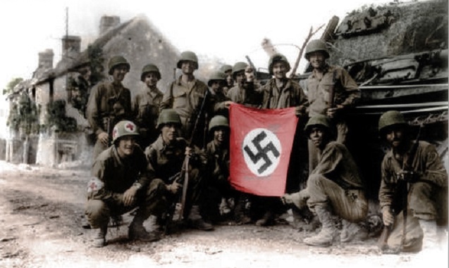 American soldiers with captured Nazi flag, WWII. (Photo: <a href=