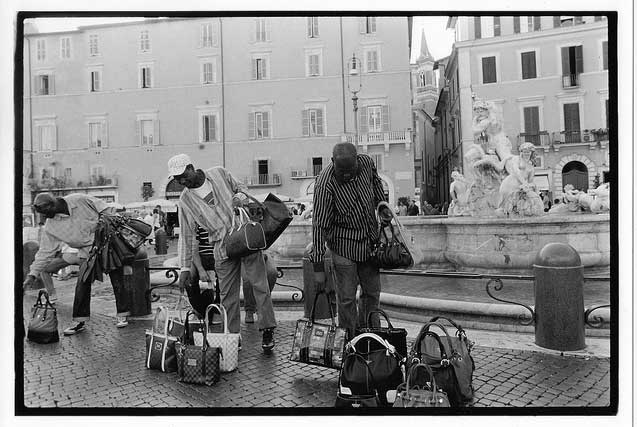 Somali immigrants selling bags on Rome street. (Photo: David Bacon)