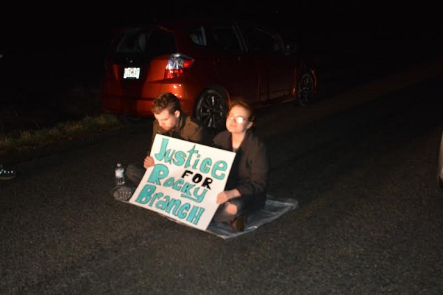 Two activists from Ohio sit in the middle of the road to support justice for residents in the Rocky Branch community in Southern Illinois faced with the consequences of Peabody Energy's strip mining expansion. (Photo: James Anderson)