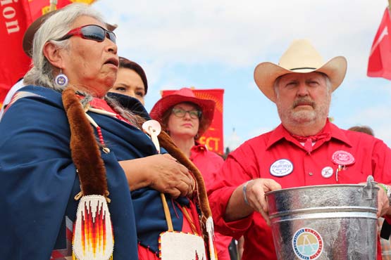 Faith Spotted Eagle and Tom Genung perform a water ceremony together at the 