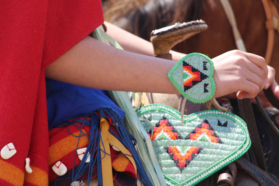 Beadwork on a rider's traditional costume.