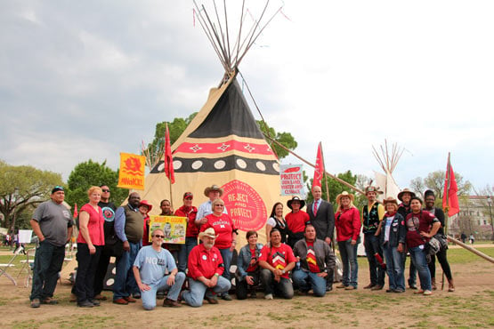 Sierra Club Executive Director Mike Brune (near center, in suit), joins members of the Cowboy and Indian Alliance at their camp.