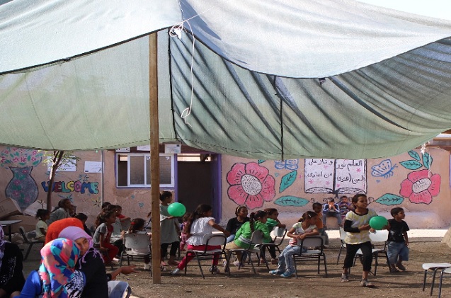 Bedouin children outside their school in Khan al-Ahmar, located in the Jordan Valley. Israel has issued a relocation order against the school and the entire village. (Photo: Kristian Davis Bailey)