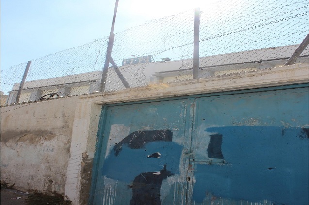 At least ten bullet holes are visible on the doors to a UN school in Aida Refugee Camp, outside of Bethlehem. The Israeli military shot upon the school in 2005, killing a teacher. (Photo: Kristian Davis Bailey)