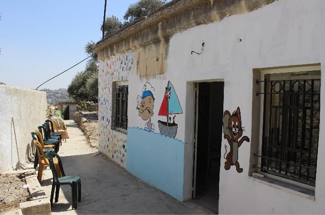 Facade of the abandoned building that Youth Against Settlements rehabilitated into a kindergarten in Hebron's H2 district last summer. (Photo: Kristian Davis Bailey)