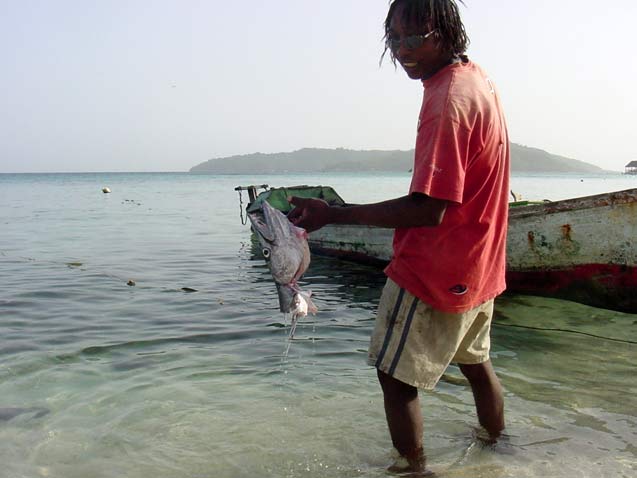 A Chachahuate resident rinses off a barracuda head before preparing a meal. (Photo: OFRANEH))