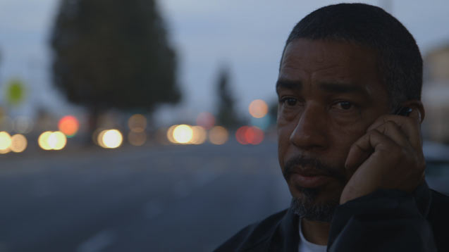 Reynaldo Reaser, LTO member, takes a phone call while on patrol. (Photo: License to Operate)