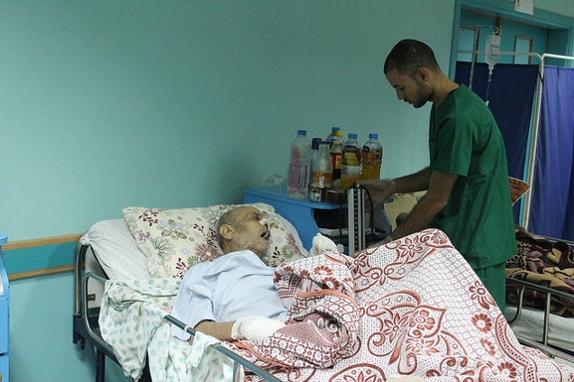 Gaza hospital damaged by Israeli shelling. A staffer tends to a patient at el-Wafa hospital in eastern Gaza City. (Photo:<a href=