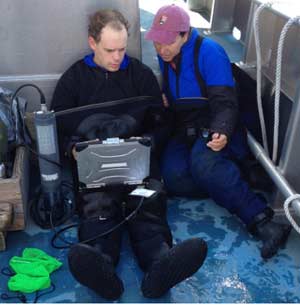 Researchers take cladophora samples from the lake. (Photo: Brian Bienkowski)