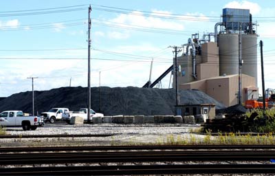 A view of the Koch brothers’ petcoke piles from the property line of a resident in the Slag Valley neighborhood of Southeast Side Chicago. (Credit Anna Simonton)