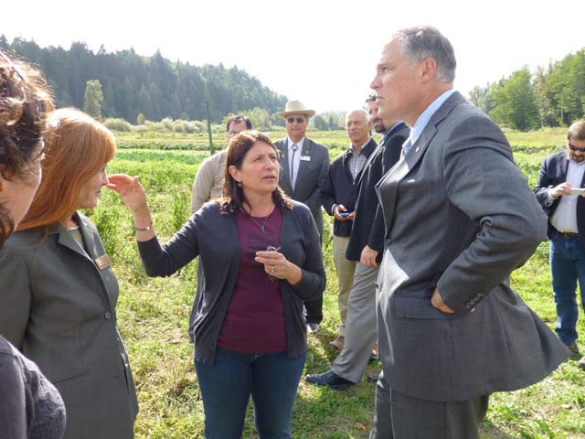 Washington farmer Susan Ujcic shows Governor Inslee an area of her farm that now regularly floods due primarily to anthropogenic climate disruption. (Photo: Dahr Jamail / Truthout)