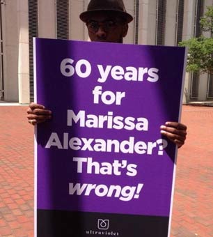 A protester holding a sign in support of Marissa Alexander.