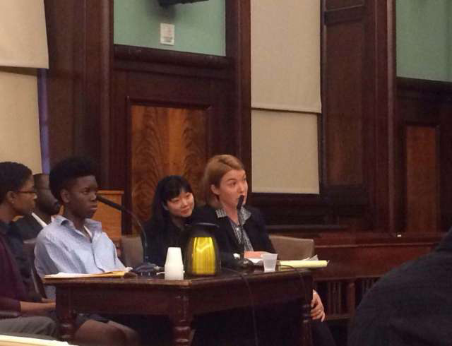 Betsy Plum testifies before the New York City Council on the issue of unaccompanied migrant minors with one of the youths from the Garifuna community seated next to her. (Photo: New York Immigration Coalition)