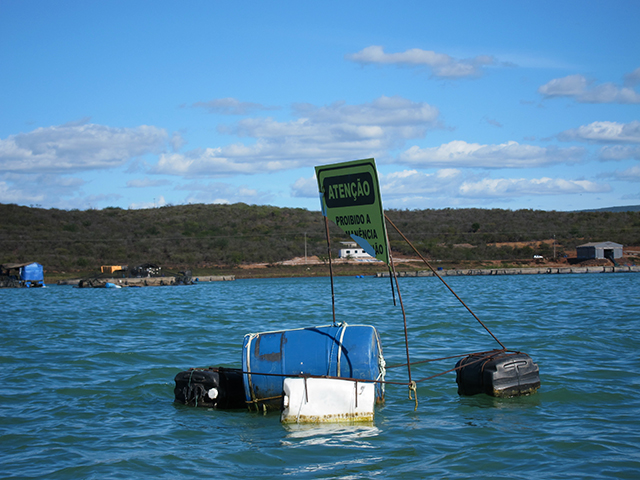 Small-scale fishermen have limited access to the water in areas where there is a growing presence of aquaculture companies. (Photo: Renata Bessi)