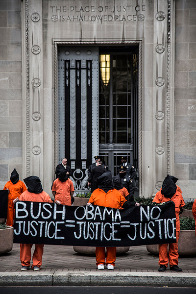 Protesters dressed as Guantánamo detainees assembled in front of the US Department of Justice to raise awareness of the men indefinitely detained and tortured by the US government. (Photo: Justin Norman)