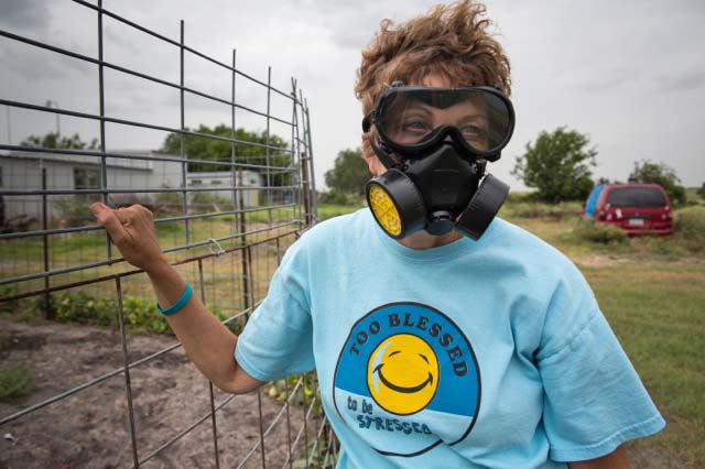 Lynn D. Buehring often wears a respirator outside of her home in Karnes County.