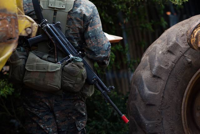 A Guatemalan soldier walks between construction equipment in the community of Pajoques a week after the official end of the state of exception. (Photo: Jeff Abbott)