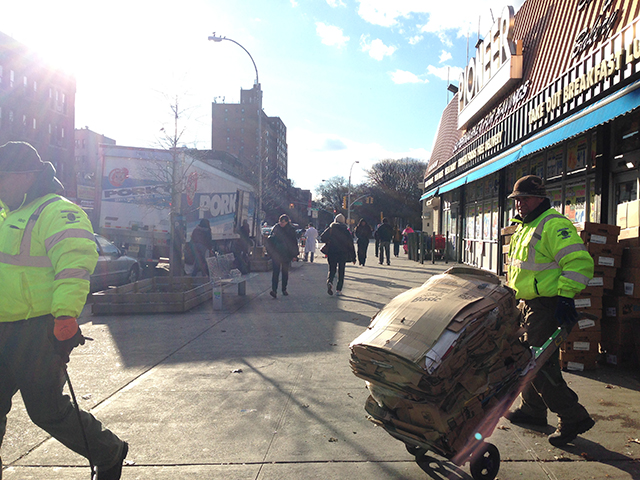 Workers haul recyclables a block from Prospect Park, near the Parkside subway stop. (Photo: Aaron Cantu)