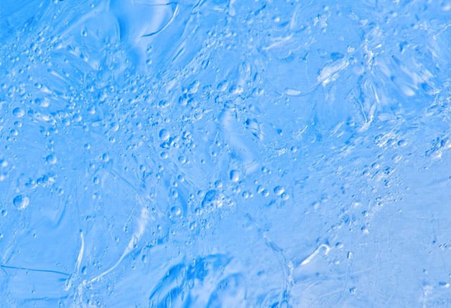 Bubbles in Greenland ice: This sample was taken from a bergy bit, which is the real scientific description for a small chunk of iceberg. It does not reveal the traditional banding of summer/winter snows, possibly because it has been reworked by folding processes on its way to the ocean. The layering is only visible in areas where ice flow is minimal such as the upper layers of ice or cores from the center of the ice sheet where ice flow has not distorted the layering. (Photo: Bruce Melton)