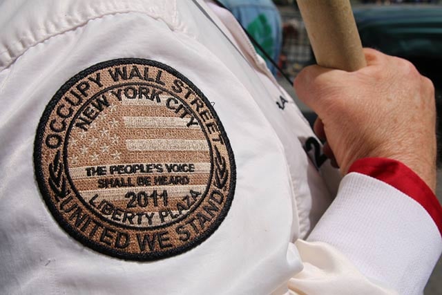 Charles Helms wears his Occupy Wall Street patch on his jacket sleeve. It was given to him in September 2011, during the first few weeks of the occupation of Zuccotti Park in New York City. (Photo: Matt Surrusco)
