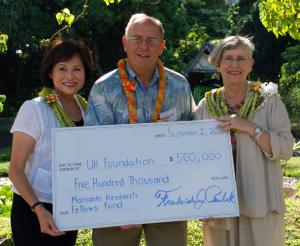 University of Hawaii officials pose with an oversize $500,000 check from Monsanto in 2010. Frederick Perlak, center, is head of Monsanto operations in Hawaii and a member of the College of Tropical Agriculture’s board of advisors. That’s his signature at the bottom of the check. To his left is Virginia Hinshaw, chancellor of the university. 