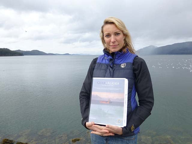 Eyak Preservation Council’s Emily Stolarcyk in Cordova, Alaska, with the Navy's environmental impact statement for their planned war games in the Gulf of Alaska. (Photo: Dahr Jamail/Truthout)