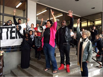 Lena Gardner (pink sweater), UU justice leader and member of First Universalist Church - Minneapolis, Pastor Danny Givens, and Rev. Ruth Mackenzie (Associate Minister at First Universalist) lead the crowd in a Black Lives Matter solidarity action for the #MOA36 at the Hennepin Co. Courthouse, May 1, 2015. (Photo: Ashley Horan)