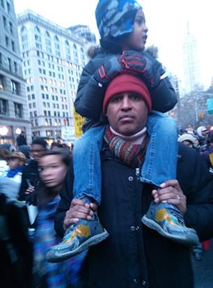 Ralphie, who contributed to Robert Glasper’s new album, rides on his father's shoulders at a #BlackLivesMatter protest in New York City. (Photo: Eisa Ulen)