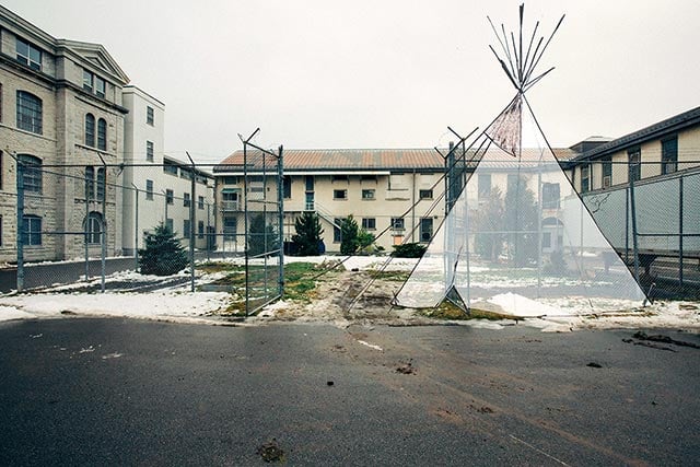 Colonialism, Continued: an illustration of a Plains-style teepee is superimposed onto a photo of a small, enclosed prison yarda place where Indigenous cultural practices would often take place. The actual teepee was packed away, as part of the decommissioning process, before Blažević had a chance to photograph it. (Photo: Cindy Blažević)