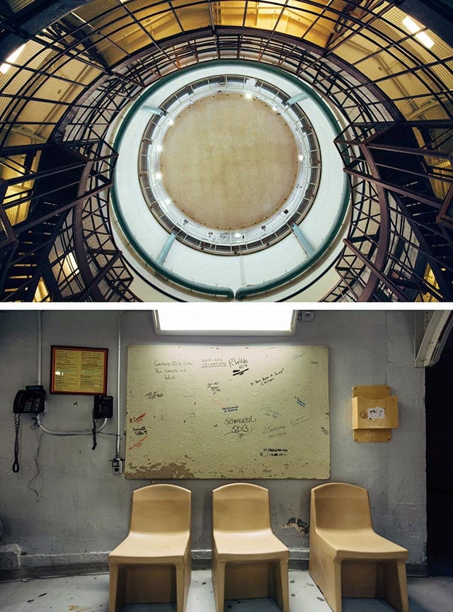 Use of Force: an upward view of the Dome. Beneath, three plastic, prisoner-designed, prisoner-made chairs (incapable of splintering or hiding contraband) sit in front of a notice board covered with the signatures of departing correctional officers. (Photo: Cindy Blažević)