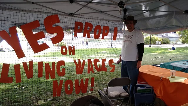 Volunteer Chris Nerisen sets up the booth for Worker Bill of Rights campaign at local event in Spokane. (Photo: Envision Spokane)