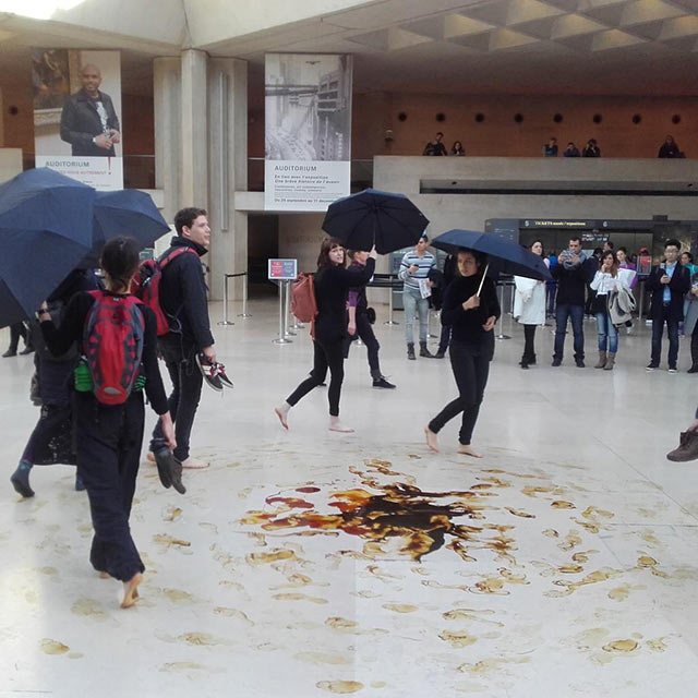Activists associated with #FossilFreeCulture performing inside the Louvre, Paris, 2015. (Photo: Clara Paillard / #FossilFreeCulture)