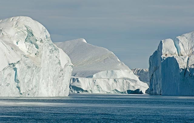 An iceberg armada disembarks from the mouth of the Ilulissat Icefjord in western Greenland. The Ilulissat Glacier (Jakobshavn Isbrae) drains seven percent of the Greenland Ice Sheet. (Photo: Bruce Melton)