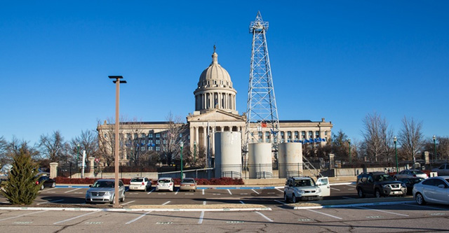 Phillips 66 oil drilling derrick with petroleum tanks in the parking lot at the Capitol Building in Oklahoma City. (Photo: Julie Dermansky)