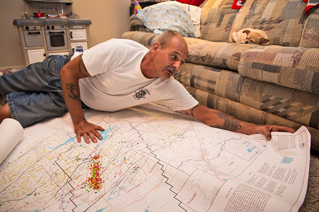 Dirk DeTurck with a map of Faulkner County, Arkansas that illustrates the earthquake swarm. (Photo: Julie Dermansky / Ocean 8 Films)