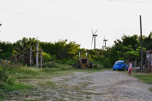 Many homes have been surrounded by wind farms across the Isthmus of Tehuantepec. (Photo: Renata Bessi)