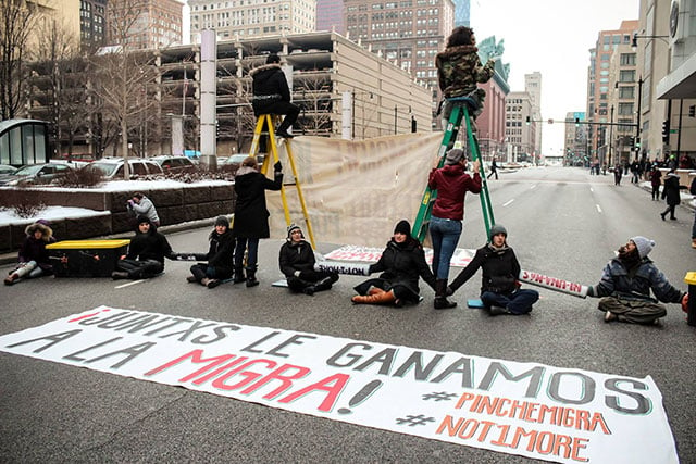 Protesters block traffic while displaying a sign in the #StopTheRaids demonstration on February 15, 2016 in Chicago, Illinois. (Photo: Tom Callahan)
