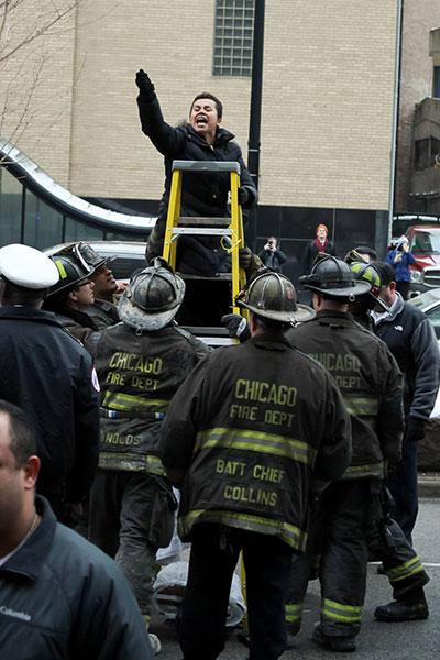A proster chained to a ladder blocks traffic at the #StopTheRaids demonstration on February 15, 2016 in Chicago, Illinois. (Photo: Tom Callahan)