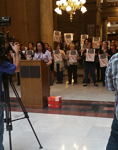 Harmony Glenn (Indy Feminists member) addresses the press inside the Indiana Statehouse surrounded by Hoosiers opposed to HEA 1337. (Photo: Indy Feminists)